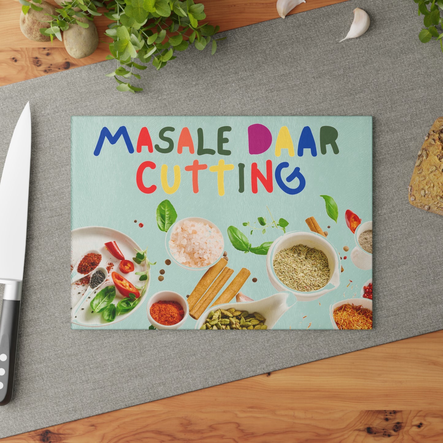 Tempered glass cutting board with desi quote “Masale Daar Cutting” surrounded by colorful Indian spice illustrations.