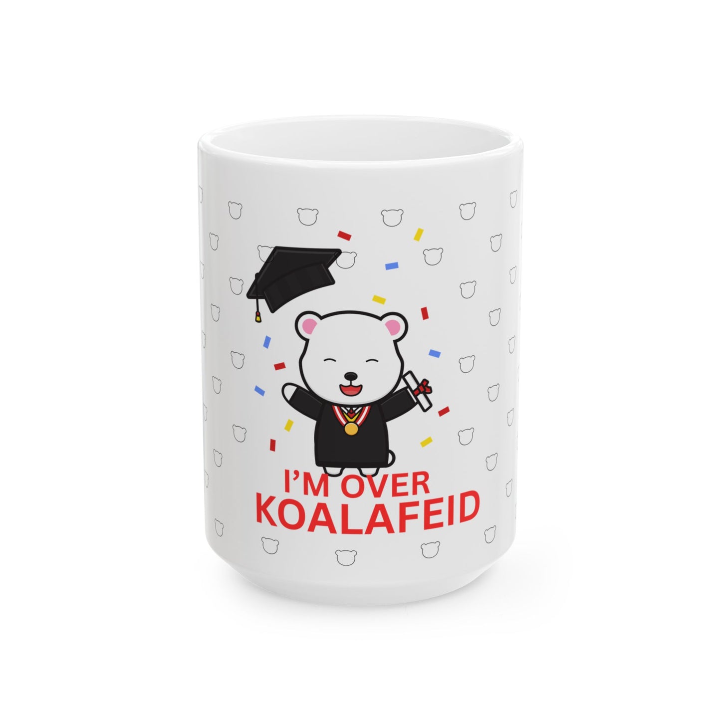 A white ceramic mug with a cartoon bear wearing a graduation cap and the text 'I'M OVER KOALAFIED' on it.