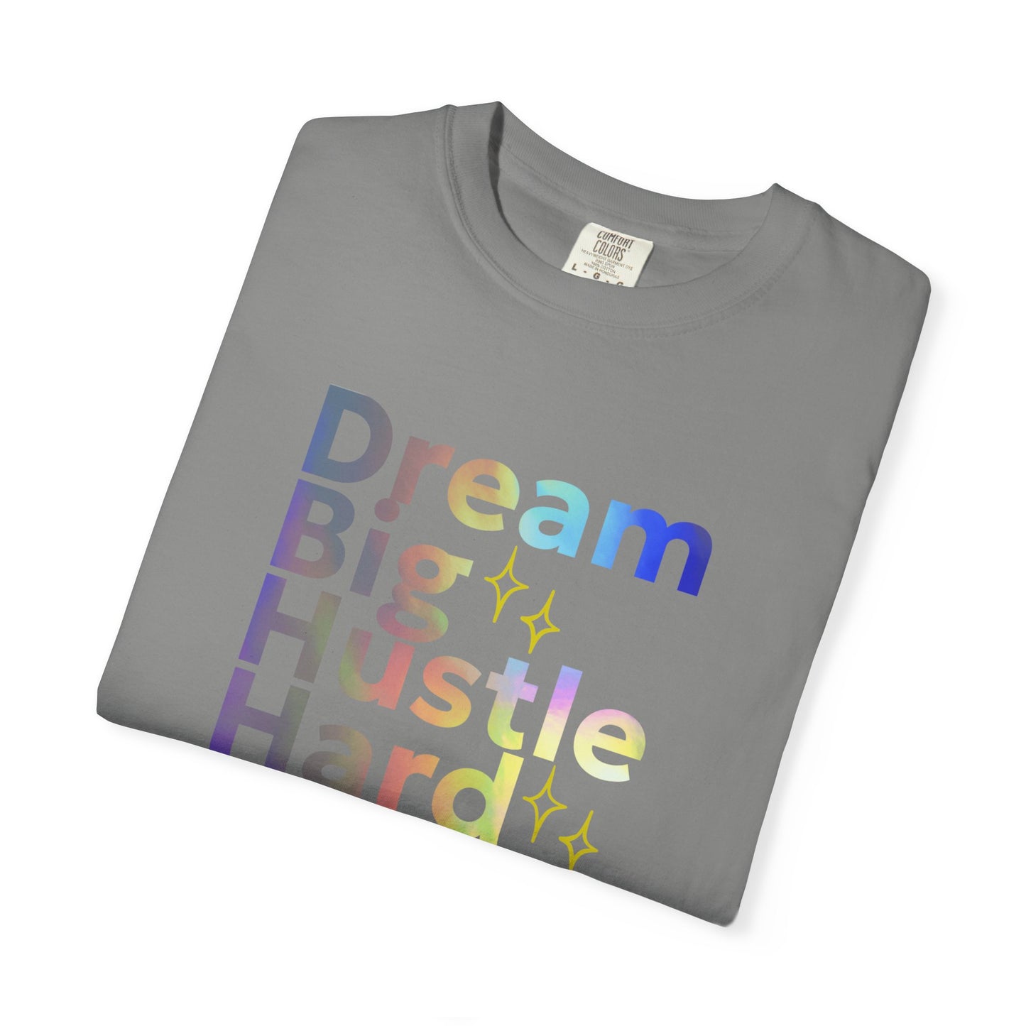 Folded gray t-shirt with colorful text 'Dream Big Hustle Hard' on a white background