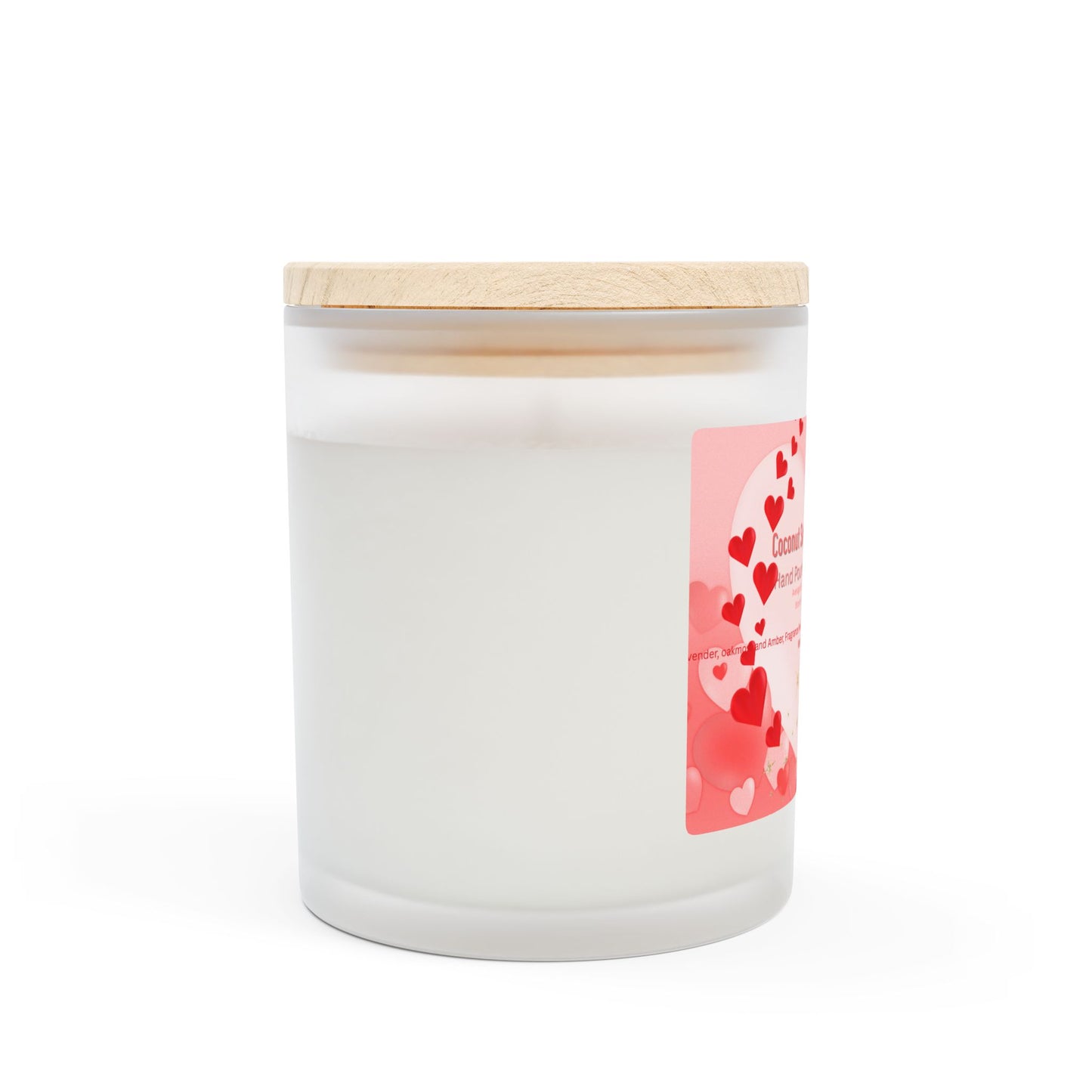 A frosted glass candle with a wooden wick and a label that includes hearts and text indicating it is made with coconut soy blended wax, hand-poured in the USA.