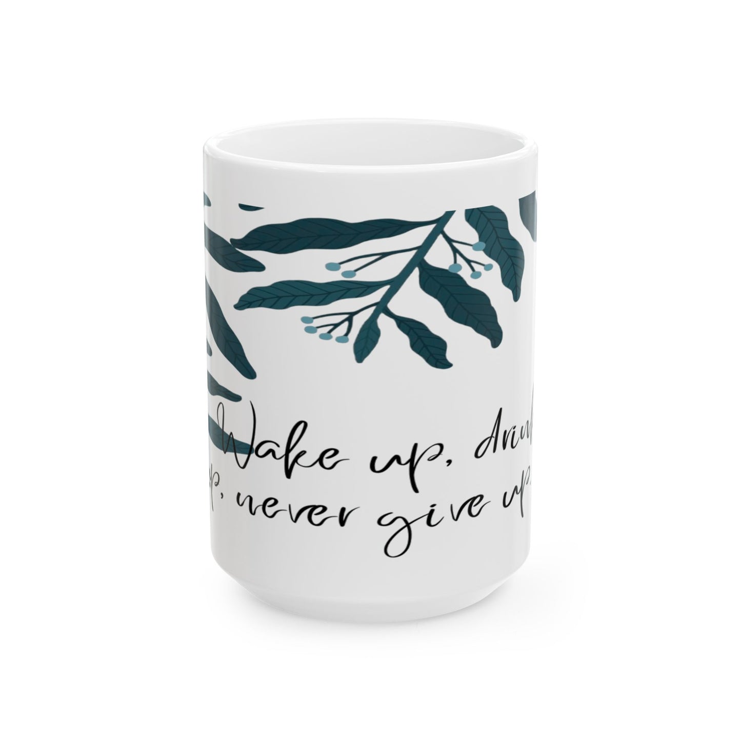 White ceramic mug with green leaf patterns and text that reads 'Wake up, and drink , never give up'.