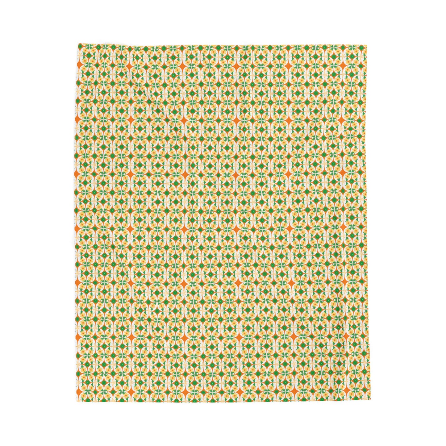 A folded velveteen plush blanket with a geometric pattern in green, yellow, and red colors.