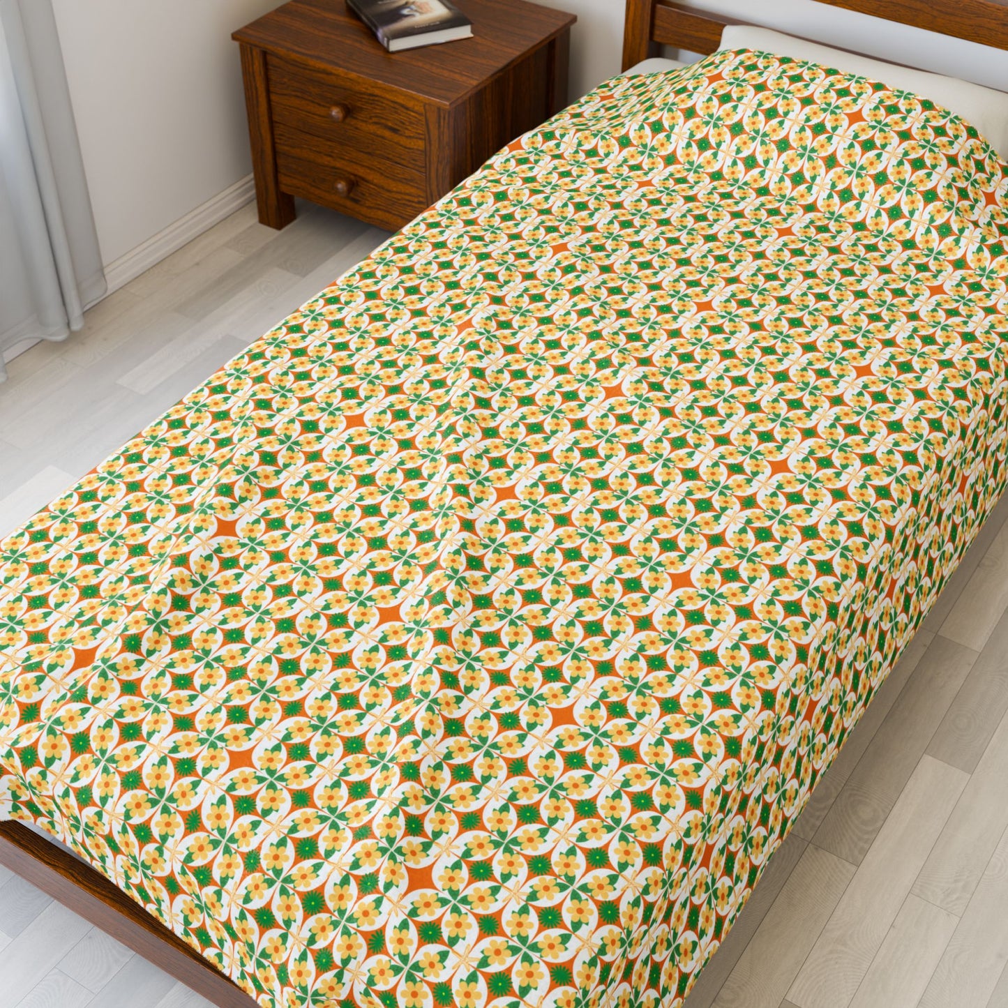 Bed with a colorful geometric patterned bedspread in a bedroom setting.