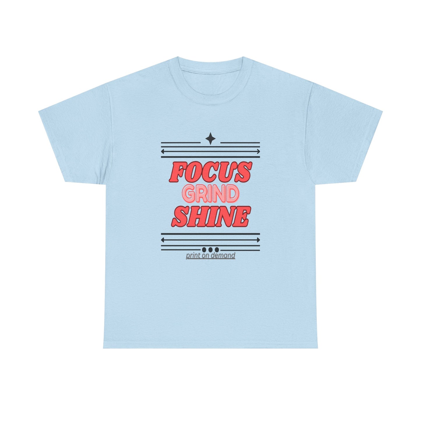 A light blue unisex heavy cotton tee with the text 'FOCUS GRIND SHINE' printed on the front.