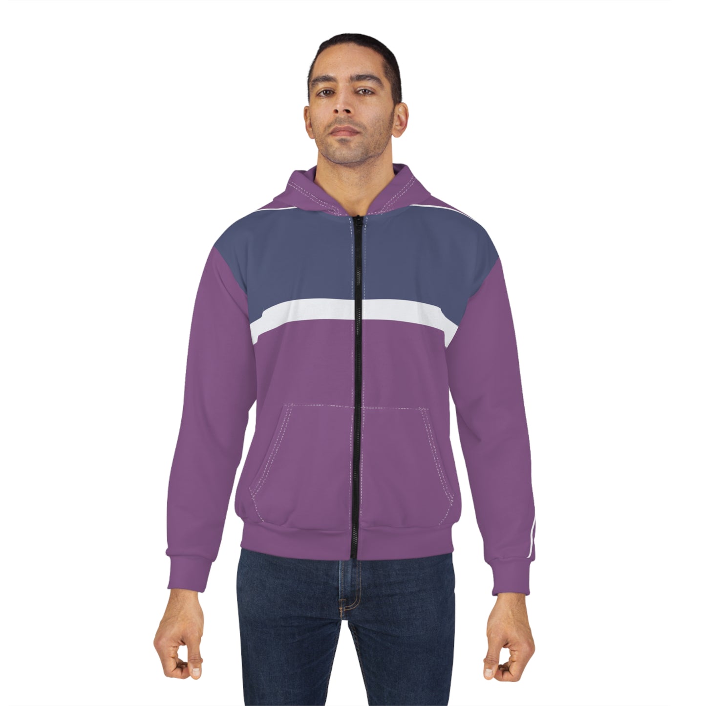 A man wearing a purple and navy blue colorblock zip-up hoodie with a white chest stripe, paired with dark blue jeans, against a plain white background.