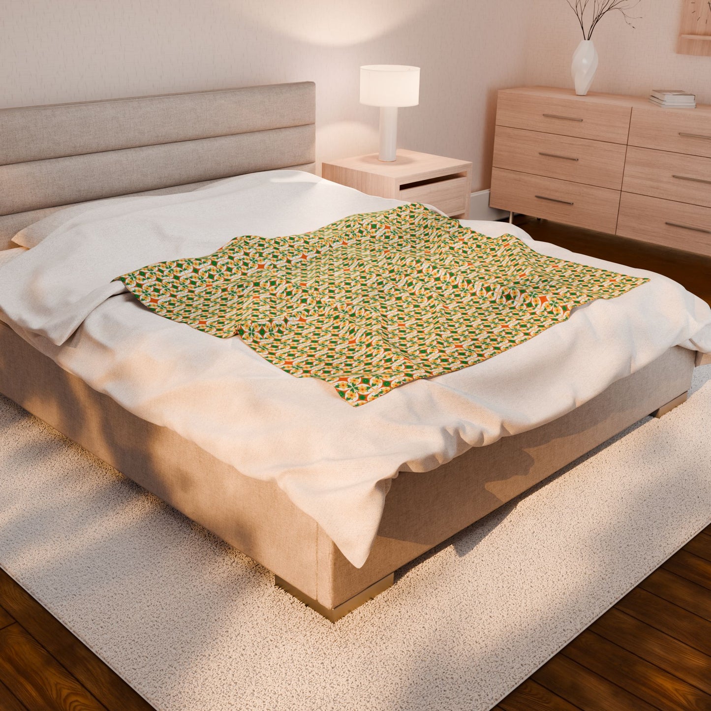 Bed with a green patterned blanket in a bedroom setting