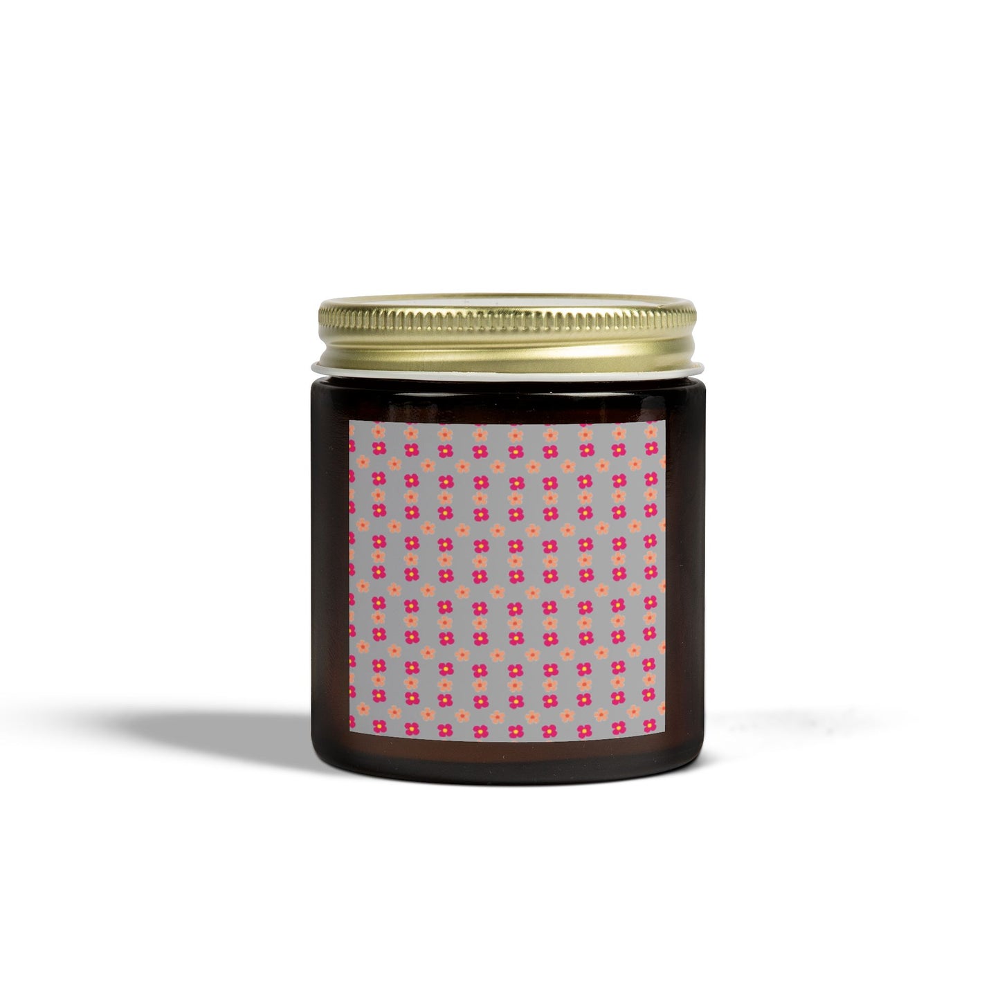 Black jar with gold lid and patterned label on a white background