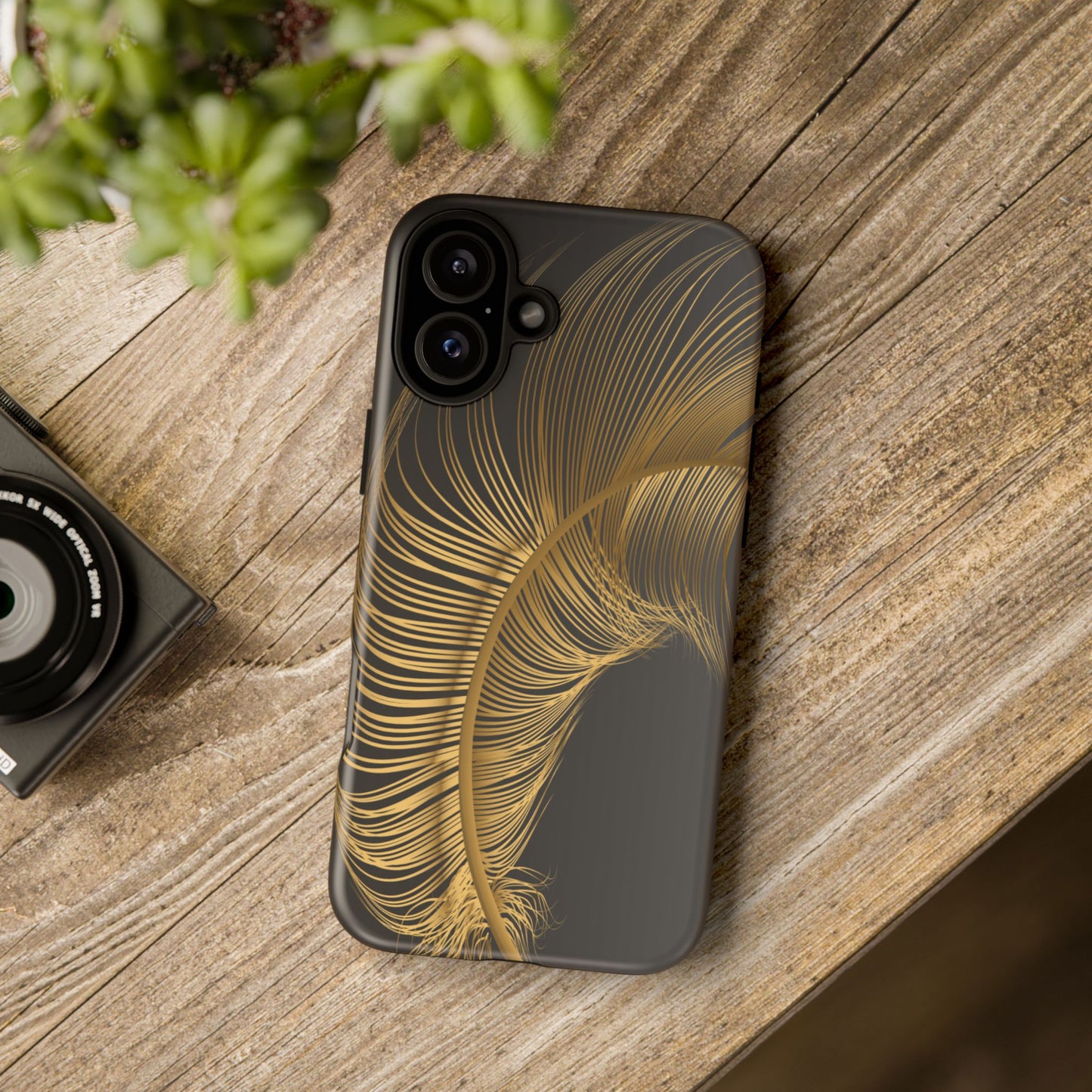 Phone case with gold feather design on black background