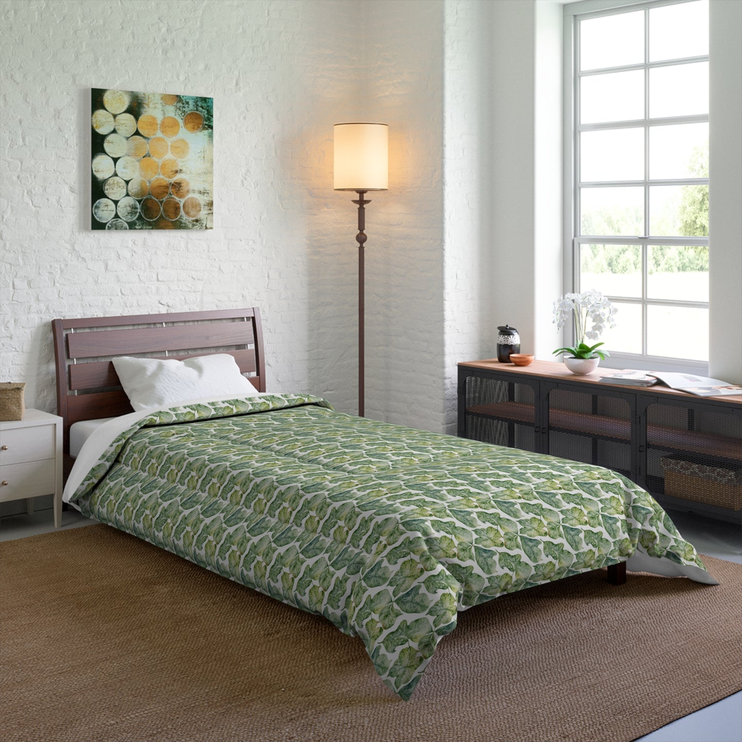 A comforter with a geometric pattern in shades of green and white, displayed against a white background.