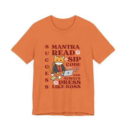 Orange t-shirt with a graphic of a cat and text on a white background