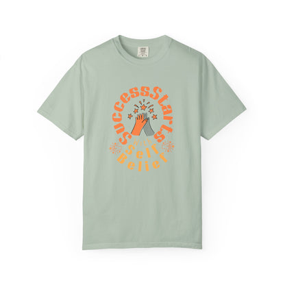 Mint green t-shirt with orange graphic design on a white background