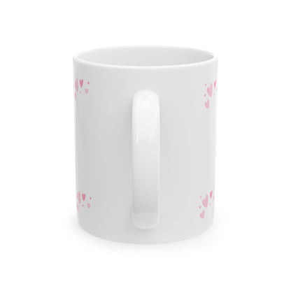 White mug with pink heart patterns on a white background