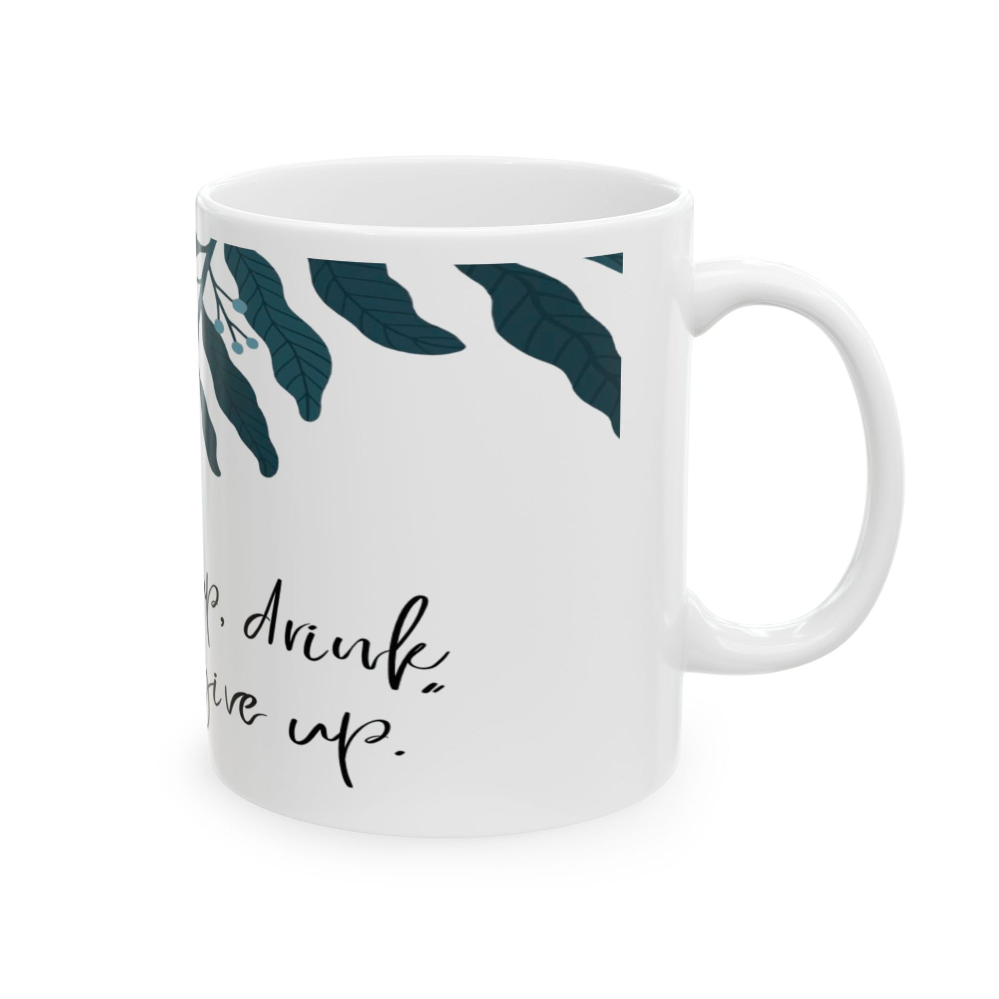 White mug with leaf pattern and text on a white background

