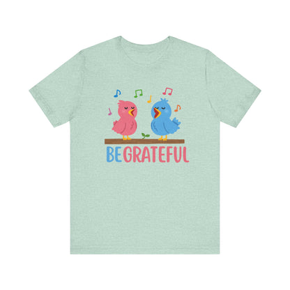 T-shirt with “Be Grateful” text and two bird illustrations – inspirational and nature-themed design for everyday wear.