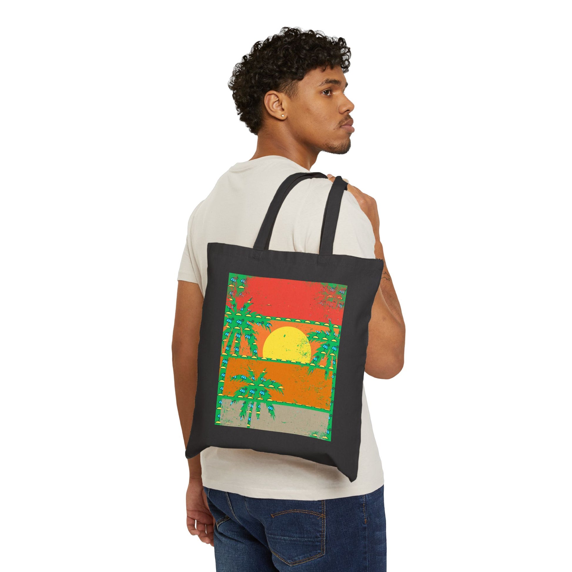 Person carrying a tote bag with a colorful design featuring a sunset and palm trees.