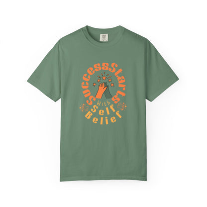 Green t-shirt with motivational graphic and text on a white background