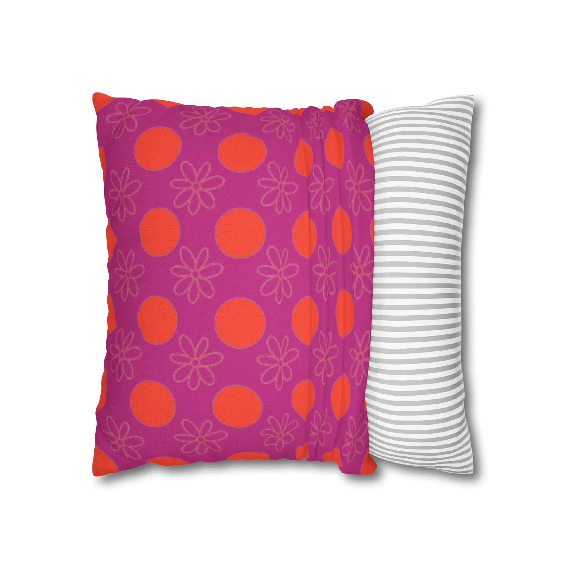 pillow with patterned covers, one pink with red circles and floral designs, the other white with gray stripes, on a white background.