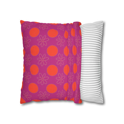 pillow with patterned covers, one pink with red circles and floral designs, the other white with gray stripes, on a white background.