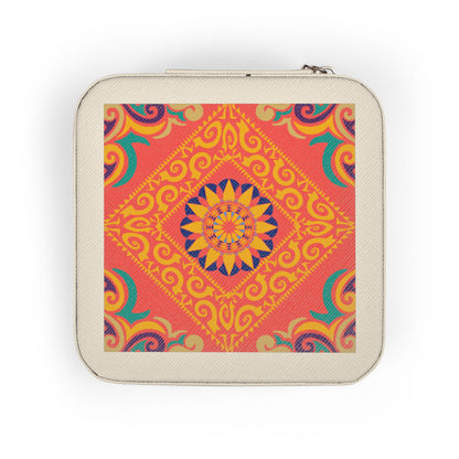 Hand holding a small square travel jewelry case with a colorful pattern on a white background