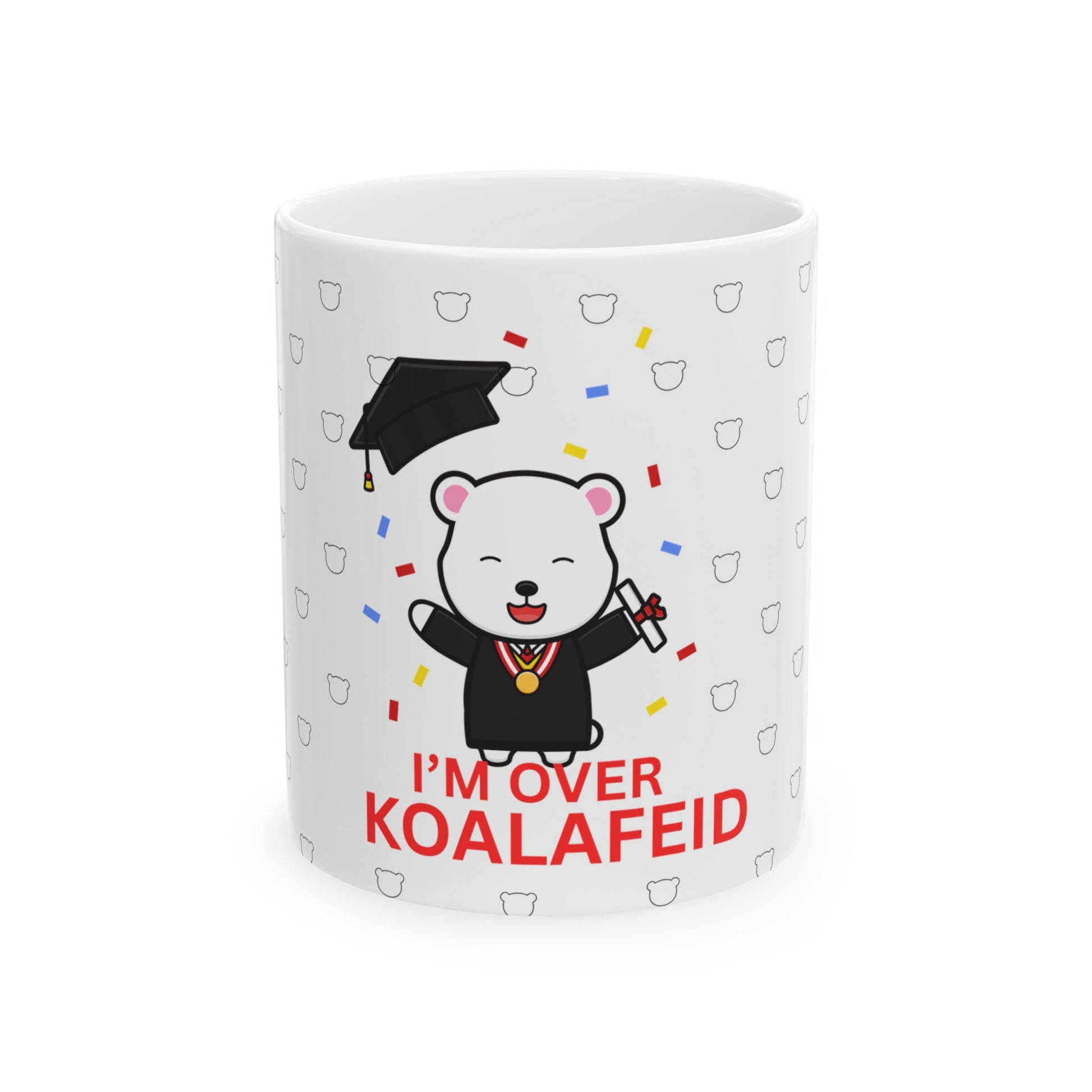 A white ceramic mug with a cartoon bear wearing a graduation cap and the text 'I'M OVER KOALAIED' on it.
