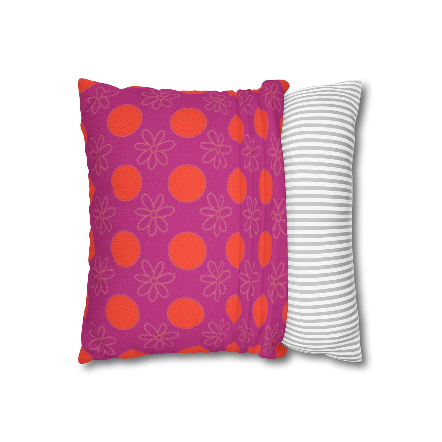  pillow with patterned covers, one pink with red circles and floral designs, the other white with gray stripes, on a white background.