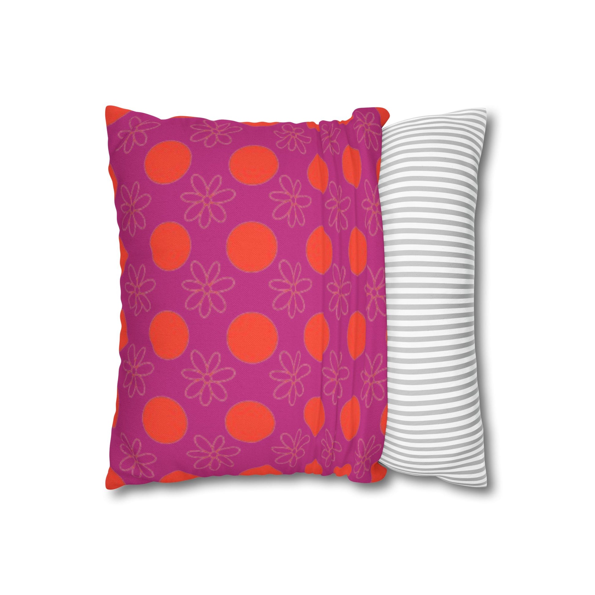  pillow with patterned covers, one pink with red circles and floral designs, the other white with gray stripes, on a white background.