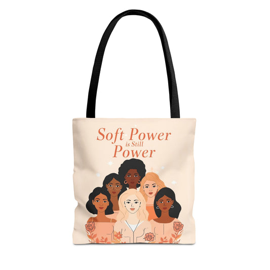 Tote bag with illustrations of diverse women and text 'Soft Power is Still Power' on a beige background