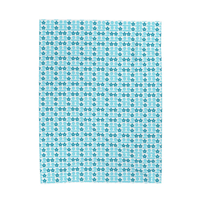 A plush blanket with a geometric pattern in blue color.