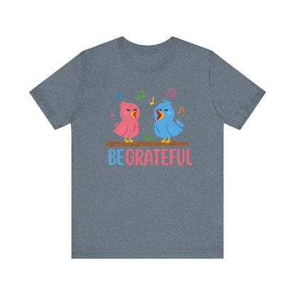 T-shirt with “Be Grateful” text and two bird illustrations – inspirational and nature-themed design for everyday wear.