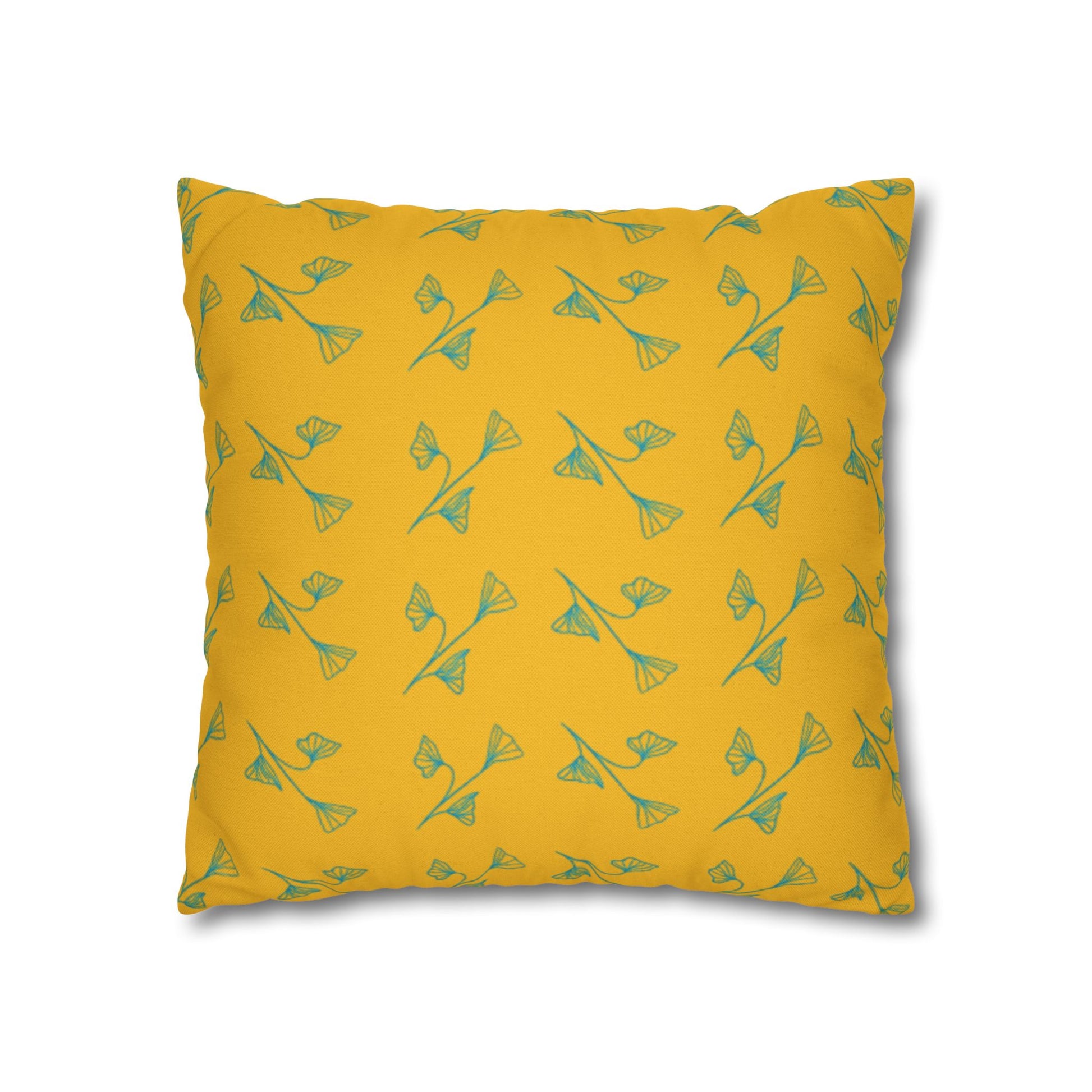 Yellow pillow with green floral pattern on a white background
