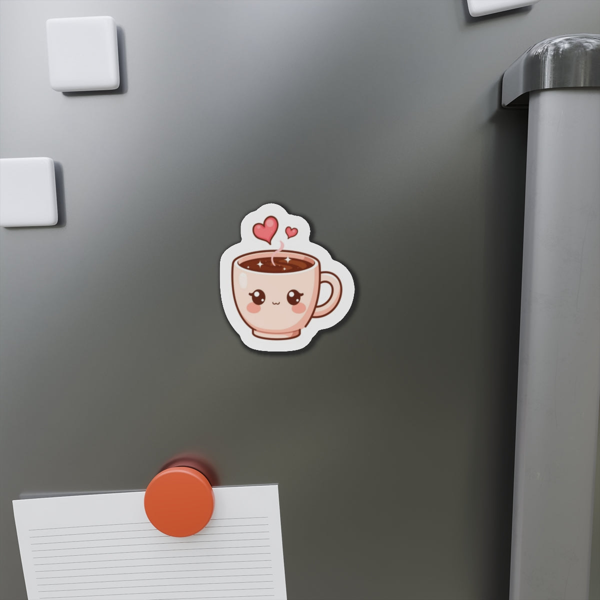Cartoon coffee cup magnet on a refrigerator with a notepad and pen.