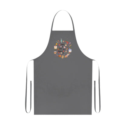 Cotton kitchen apron with "Bake it till you make it" text and circular illustrations of cake, biscuit, cone, and baking utensils.

