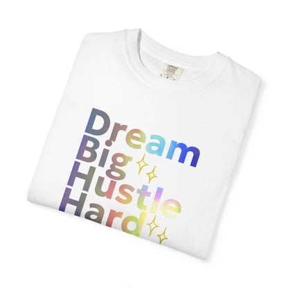 White t-shirt with colorful text 'Dream Big Hustle Hard' on a white background
