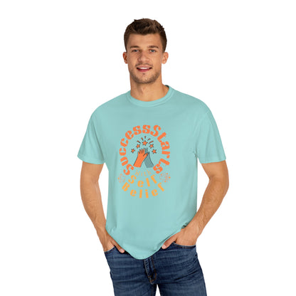 Man wearing a light blue t-shirt with a graphic design on a white background