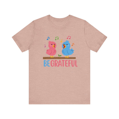 T-shirt with “Be Grateful” text and two bird illustrations – inspirational and nature-themed design for everyday wear.