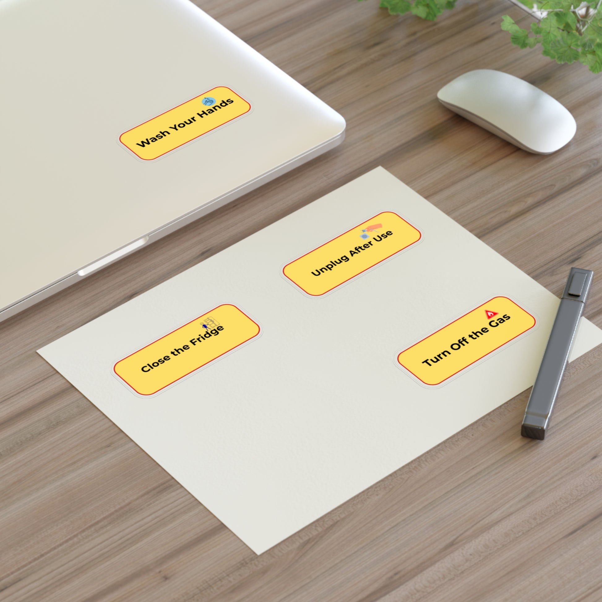 Set of safety labels on a desk with a computer mouse and pen.