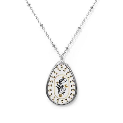 Teardrop-shaped pendant with floral design on a white background