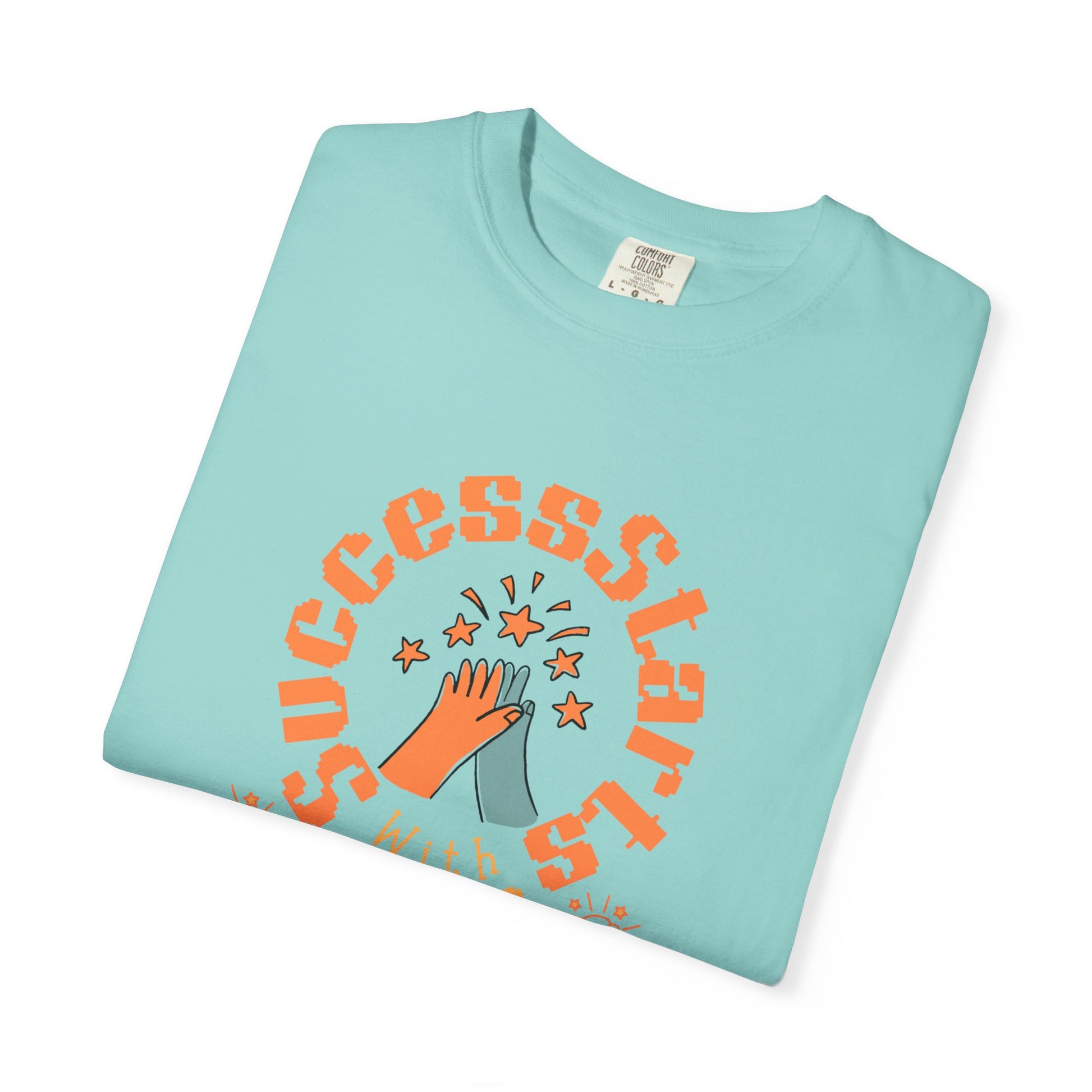 Folded light blue t-shirt with orange text and graphic on a white background
