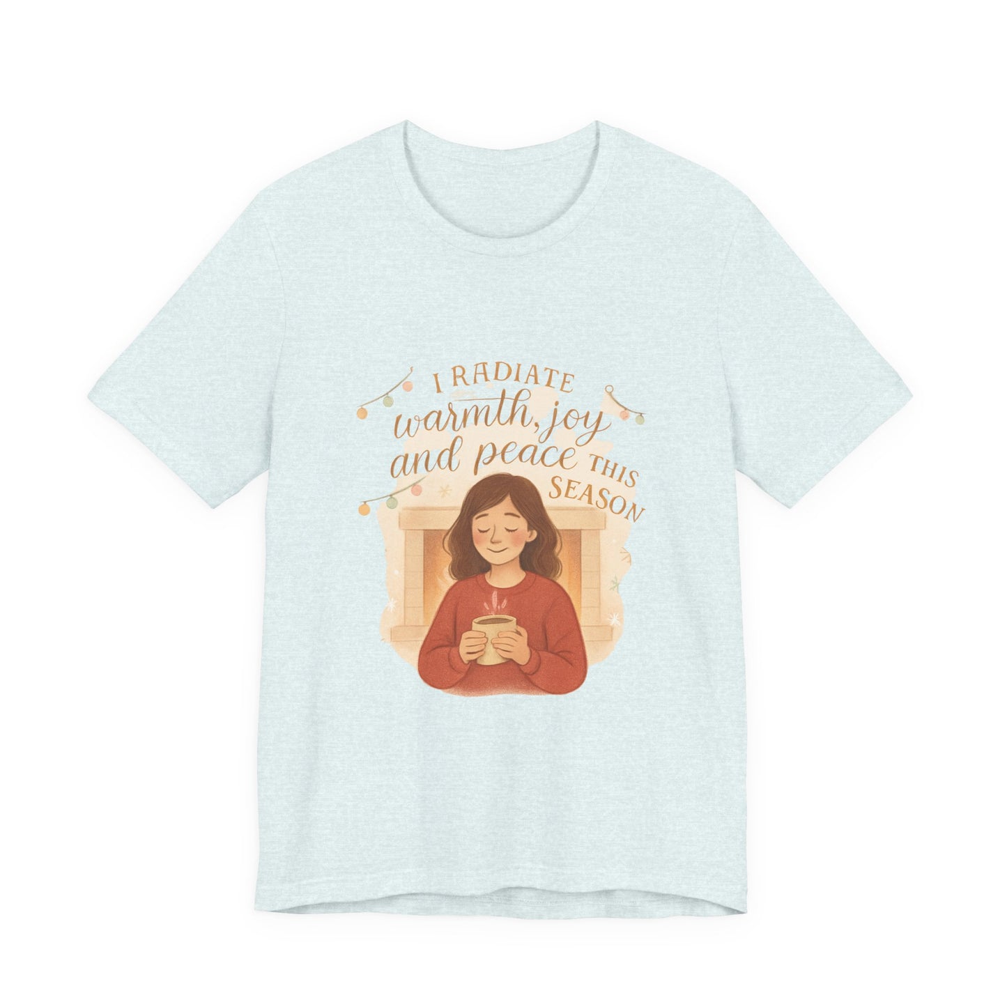 Light blue t-shirt with a graphic of a person holding a mug and text 'I radiate warmth, joy, and peace this season' on a white background.
