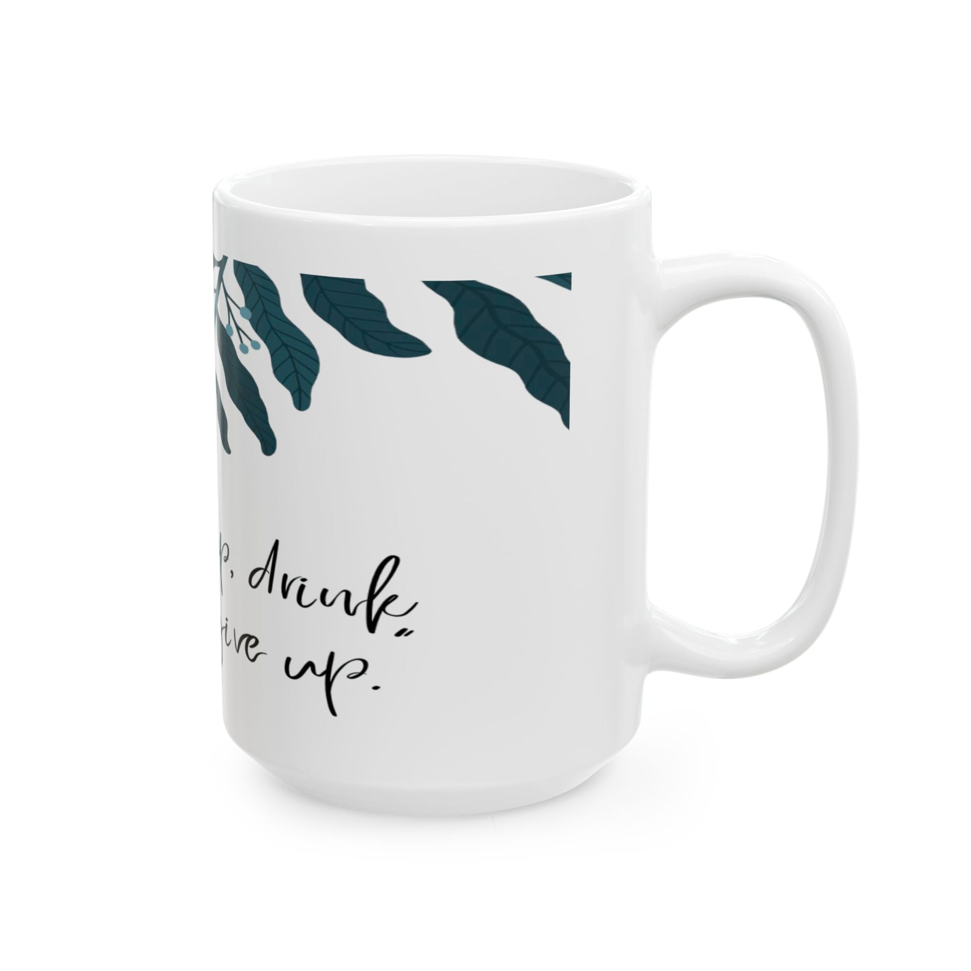 White mug with leaf pattern and text on a white background