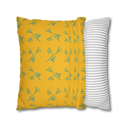 Yellow pillow with green leaf pattern and gray and white striped pillow on white background