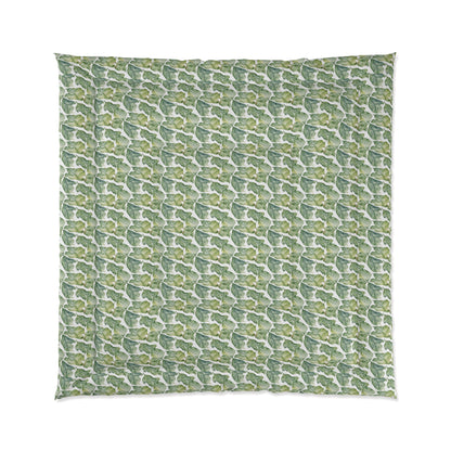 A comforter with a geometric pattern in shades of green and white, displayed against a white background.