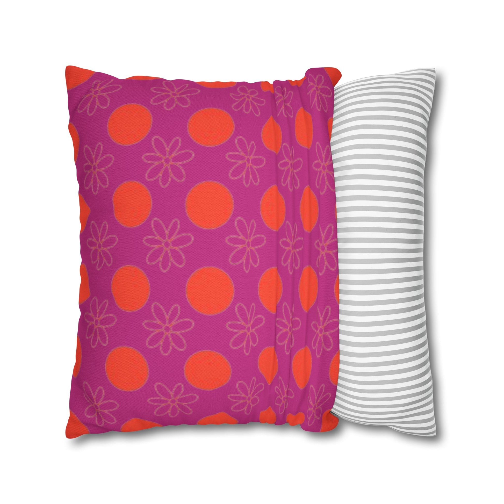  pillow with patterned covers, one pink with red circles and flowers, the other white with gray stripes, on a white background.