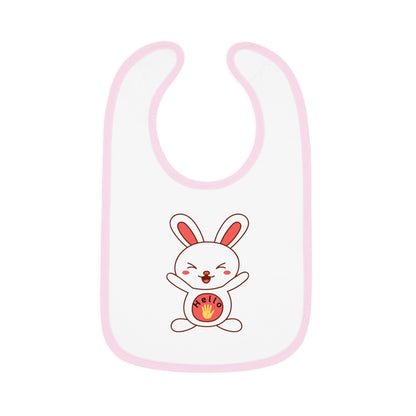 A white baby bib with pink contrast trim and a centered graphic of a smiling cartoon rabbit holding a round object.