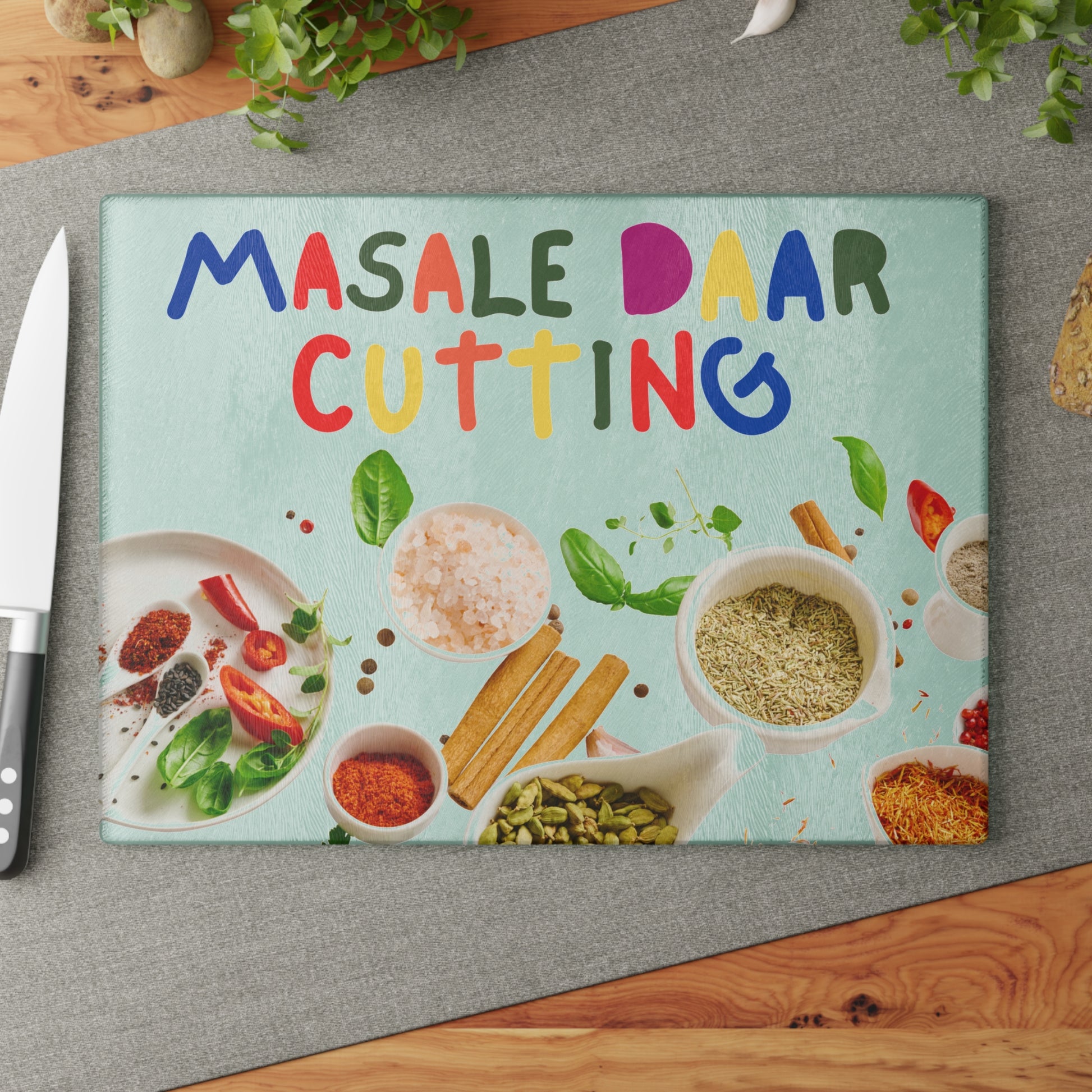 Tempered glass cutting board with desi quote “Masale Daar Cutting” surrounded by colorful Indian spice illustrations.