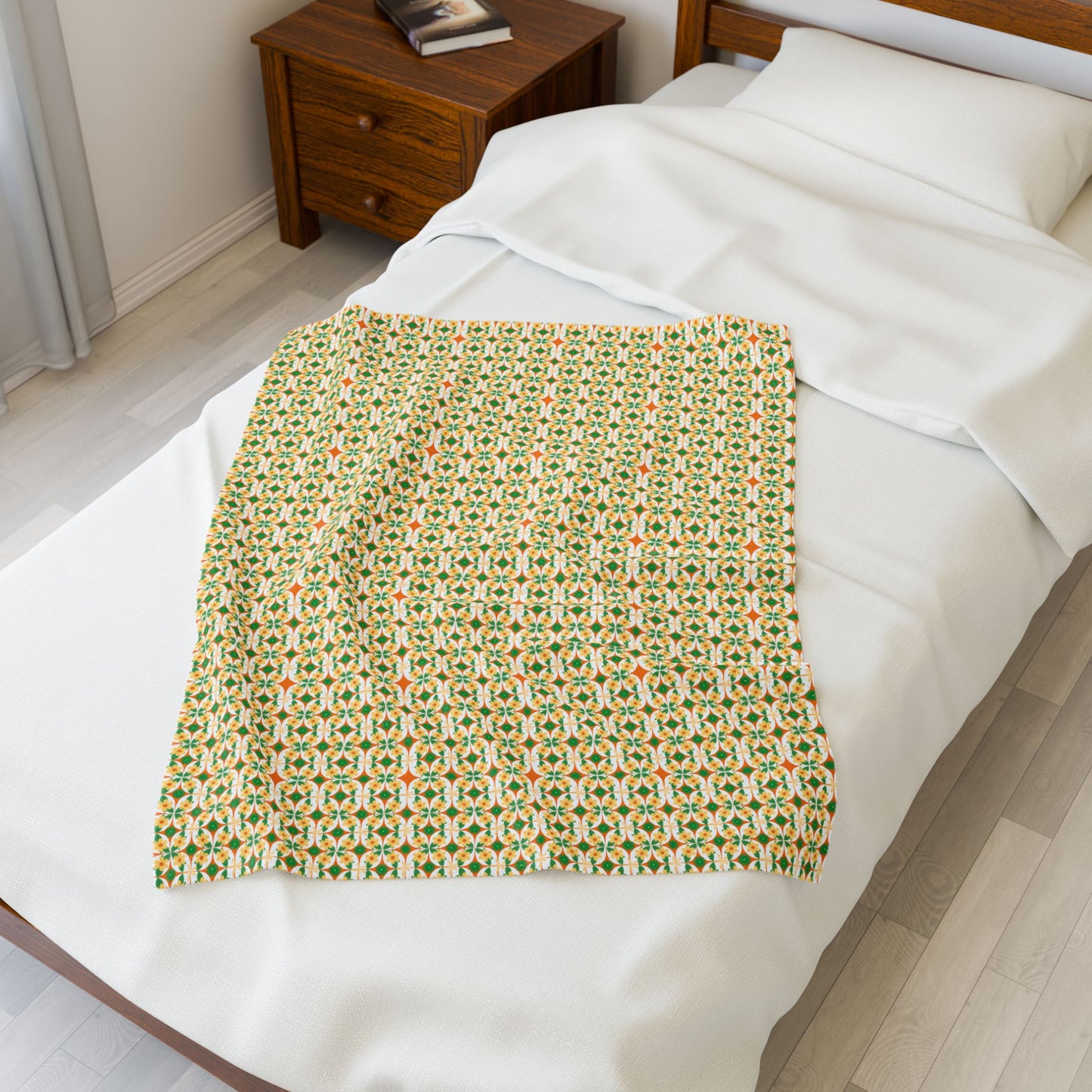 Patterned blanket on a bed in a bedroom.