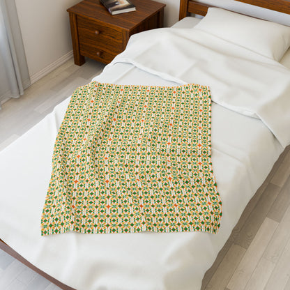 Patterned blanket on a bed in a bedroom.