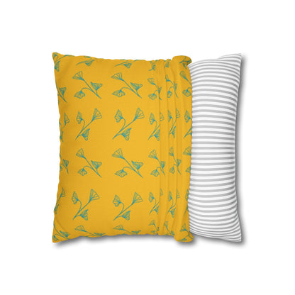 Yellow pillow with green leaf pattern and gray and white striped pillow on white background