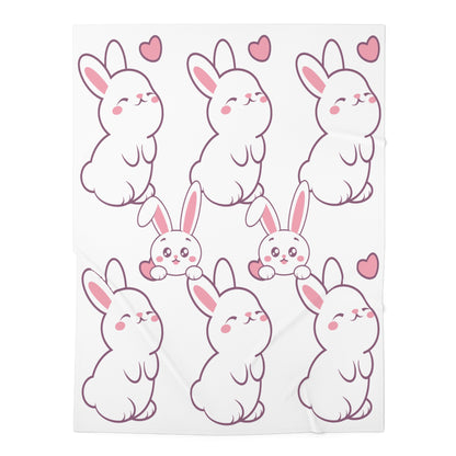 A white baby swaddle blanket with a sublimation print of cute rabbits in various poses, with hearts in the background.