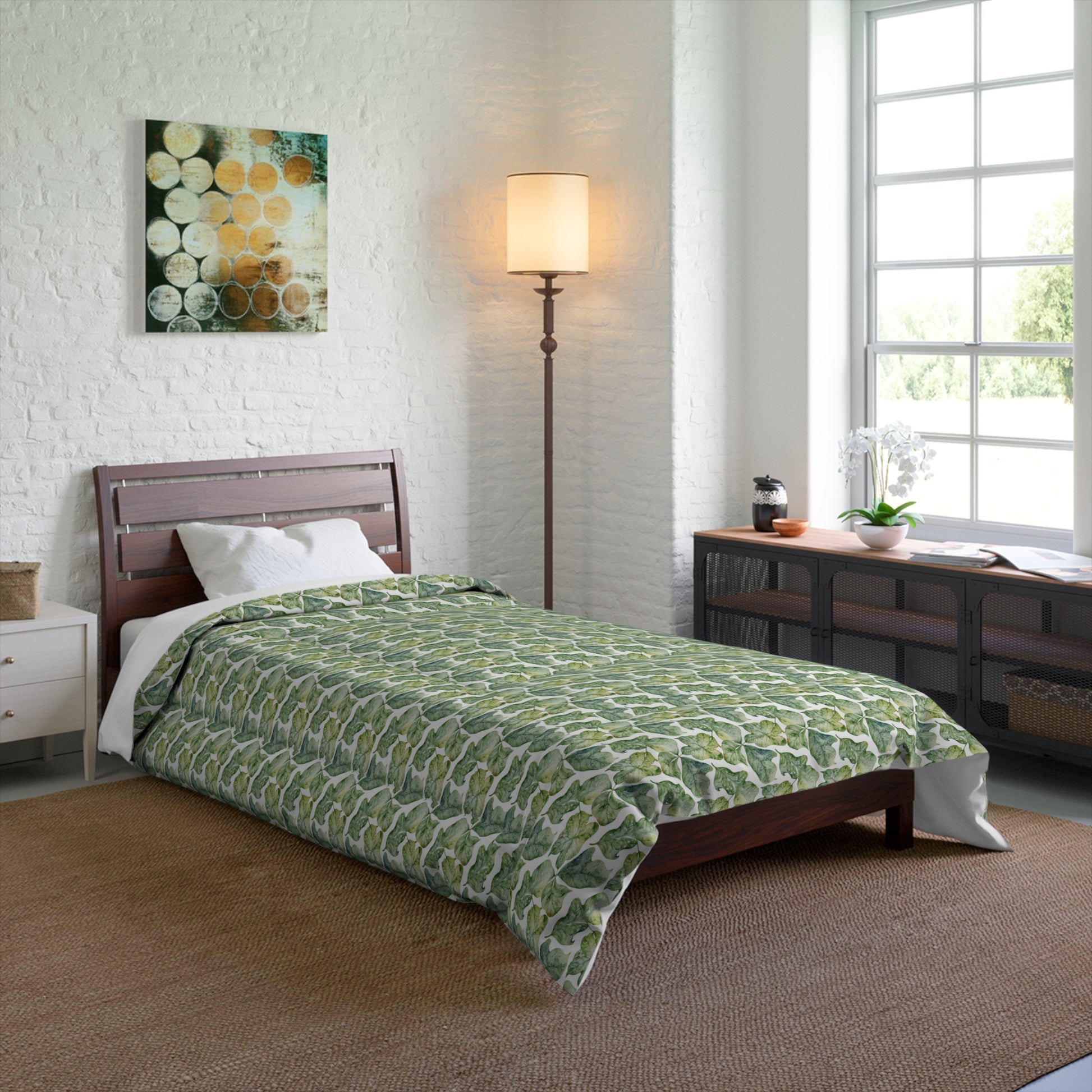 Bedroom with a green patterned comforter on a bed.